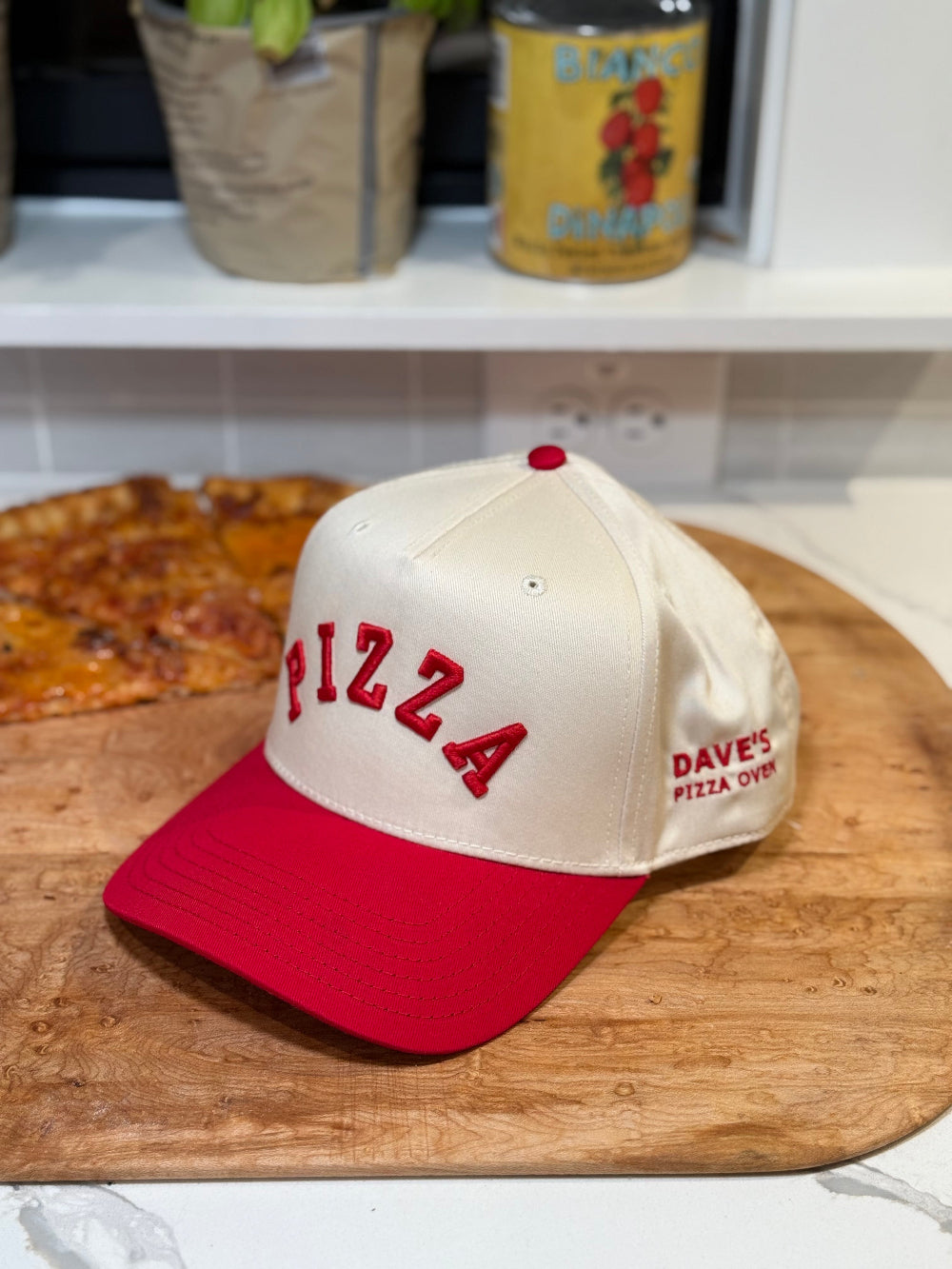 white and red cap with PIZZA text
