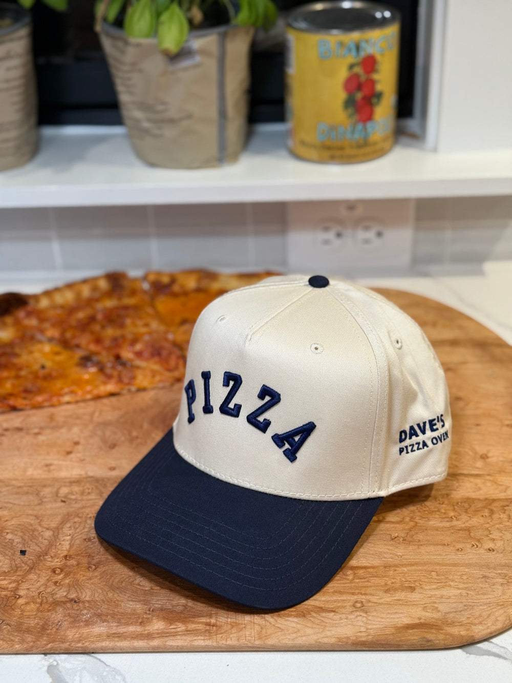 white and navy cap with PIZZA text