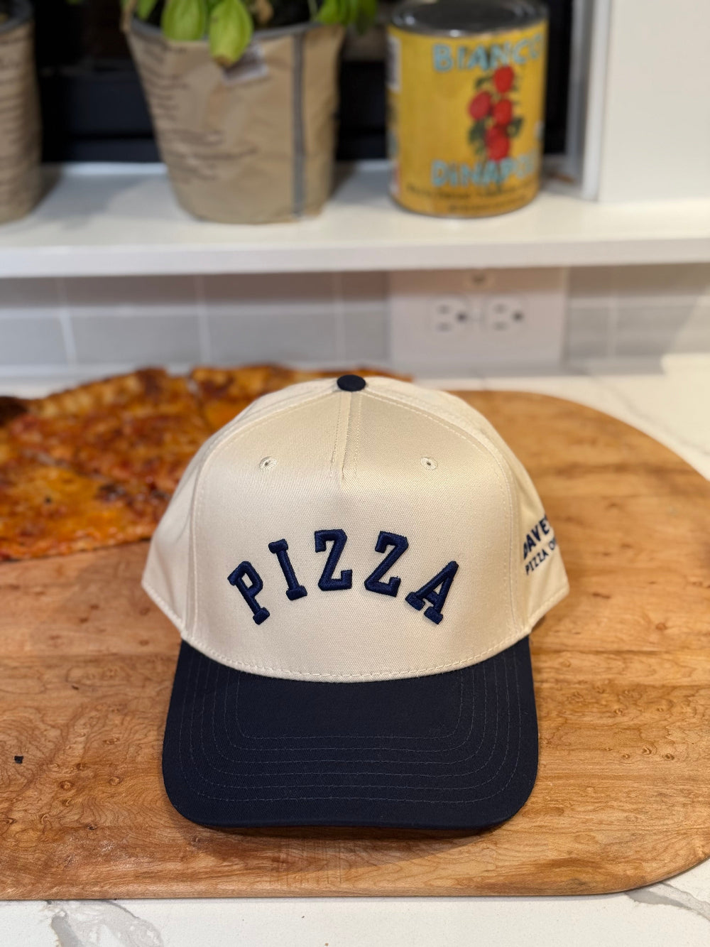 white and navy cap with PIZZA text